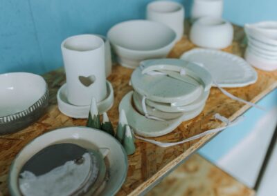 Artisanal pottery on a wooden shelf with a rustic feel, perfect for home decor.